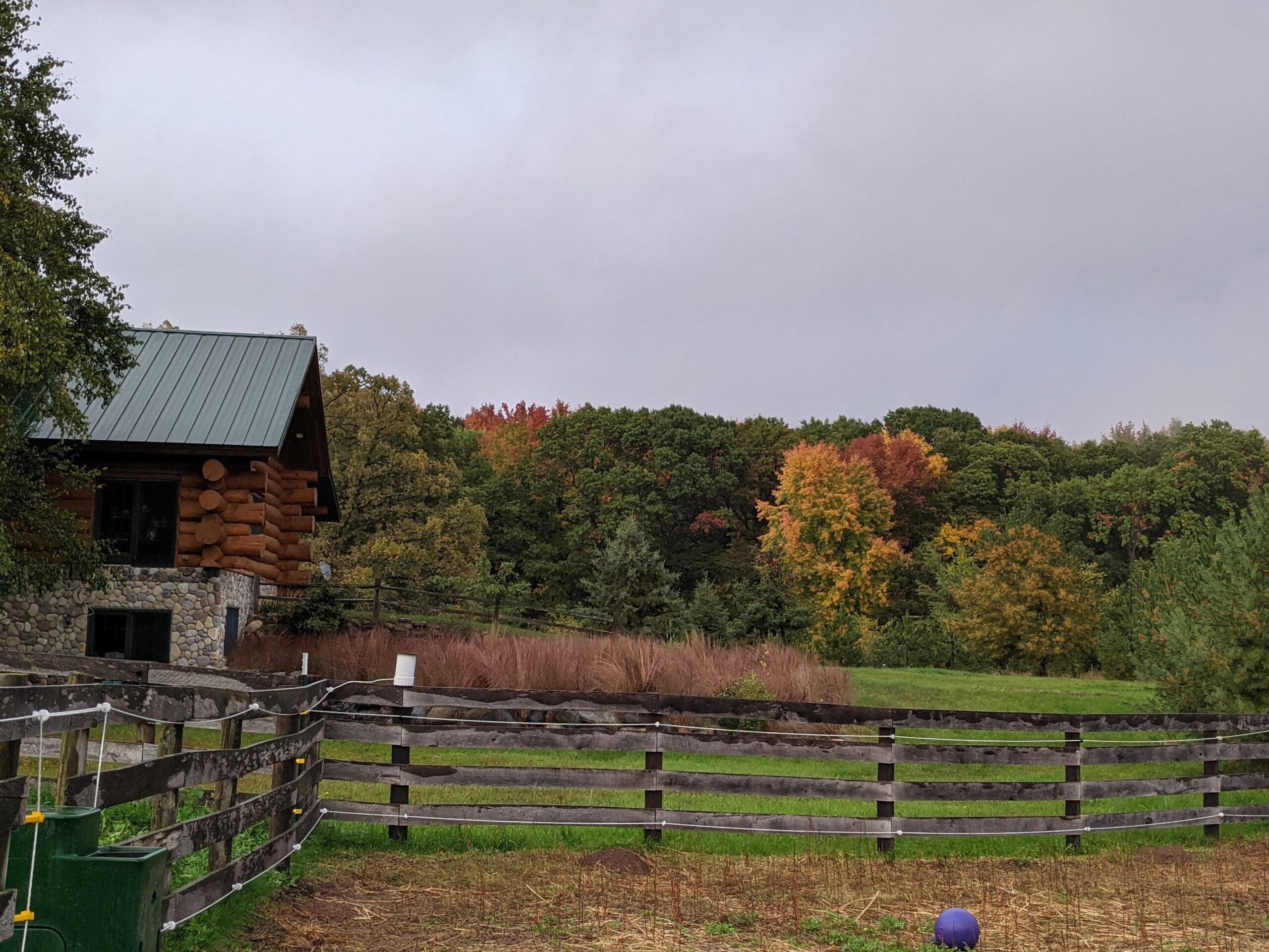 farm with log cabin in autumn