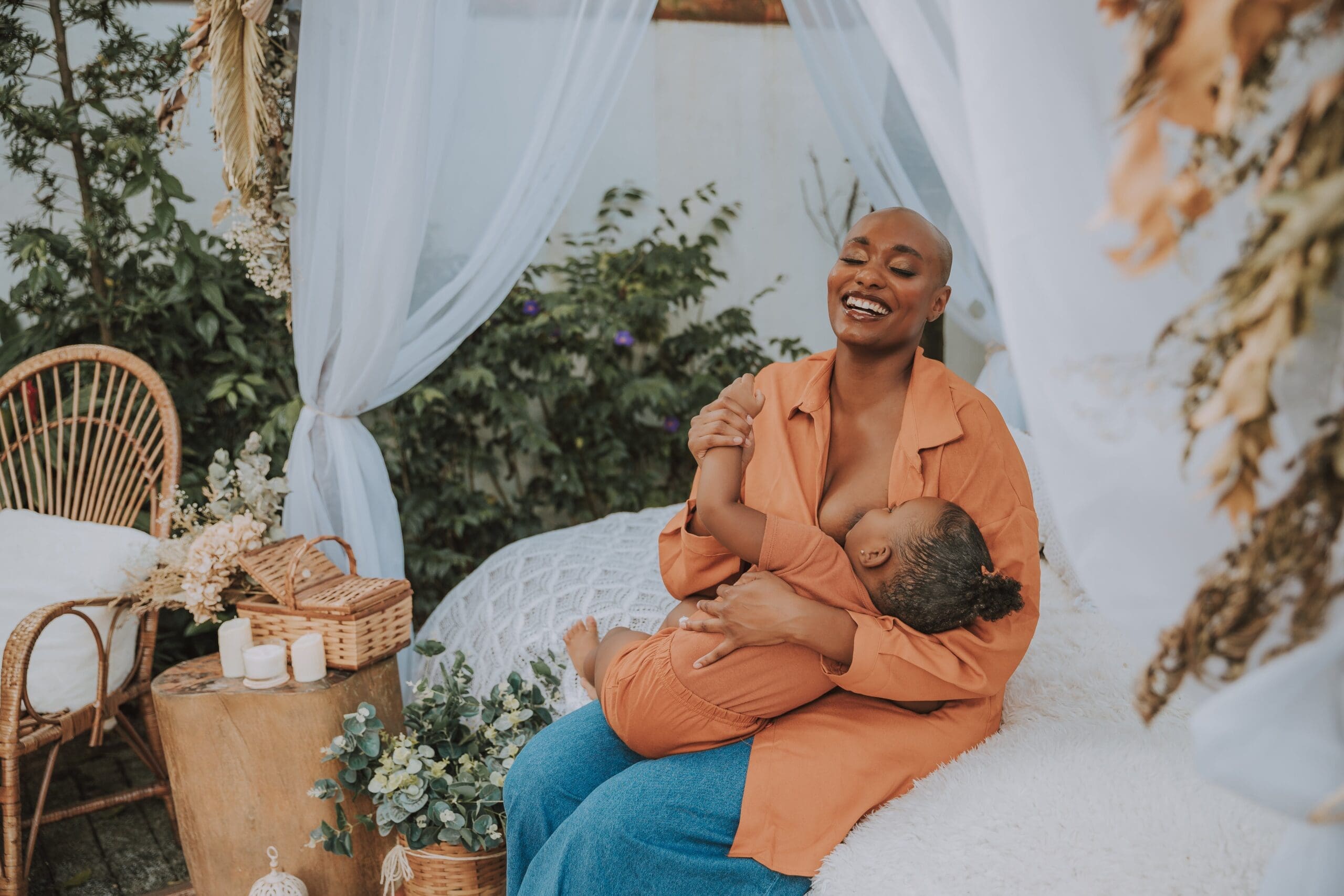 woman sitting on bed holding child